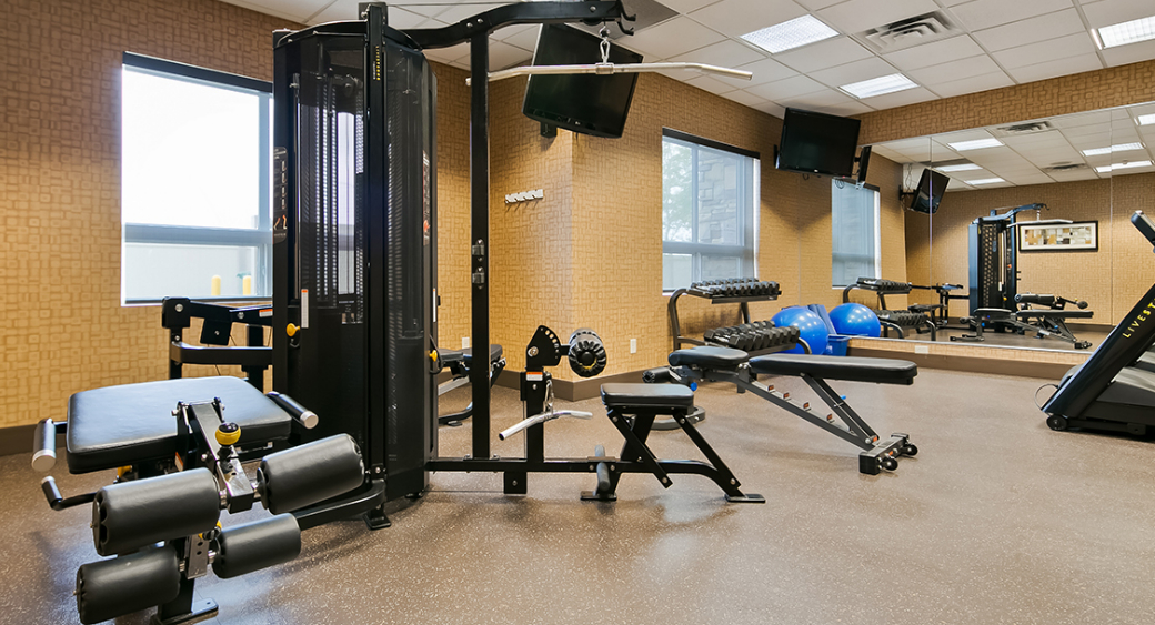 fitness room with weight and cardio machines