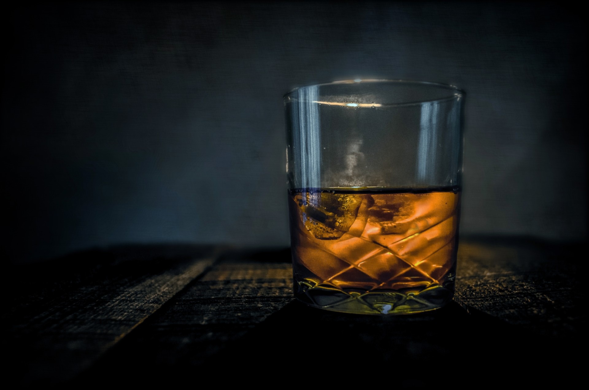 whiskey glass on a wood countertop